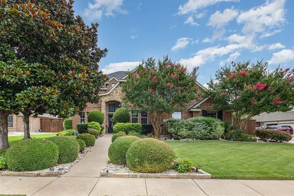 a front view of a house with a yard and a garage