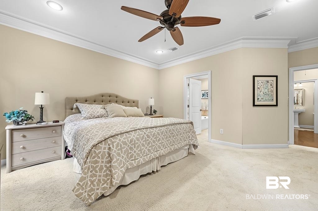 29976 Dolive Ridge Daphne, AL 36527 - Photo 30 of 58 Carpeted bedroom with crown molding, ensuite bathroom, and ceiling fan