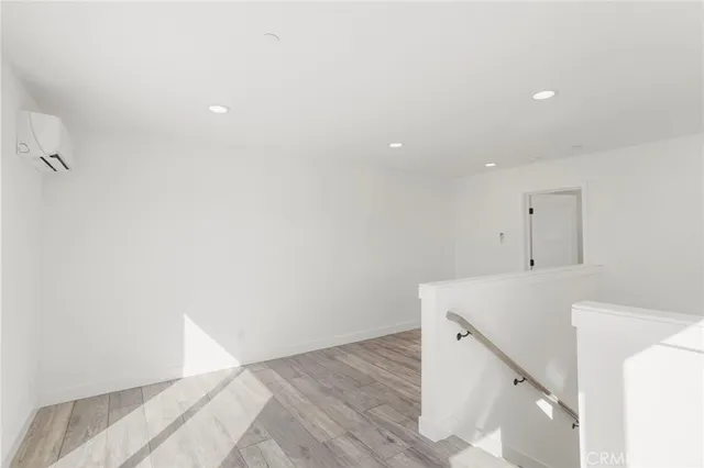 a view of a kitchen with white cabinets and wooden floor