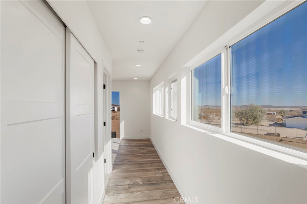 3460 Stonehill Avenue Joshua Tree, CA 92252 - Photo 14 of 27 a view of a hallway with windows