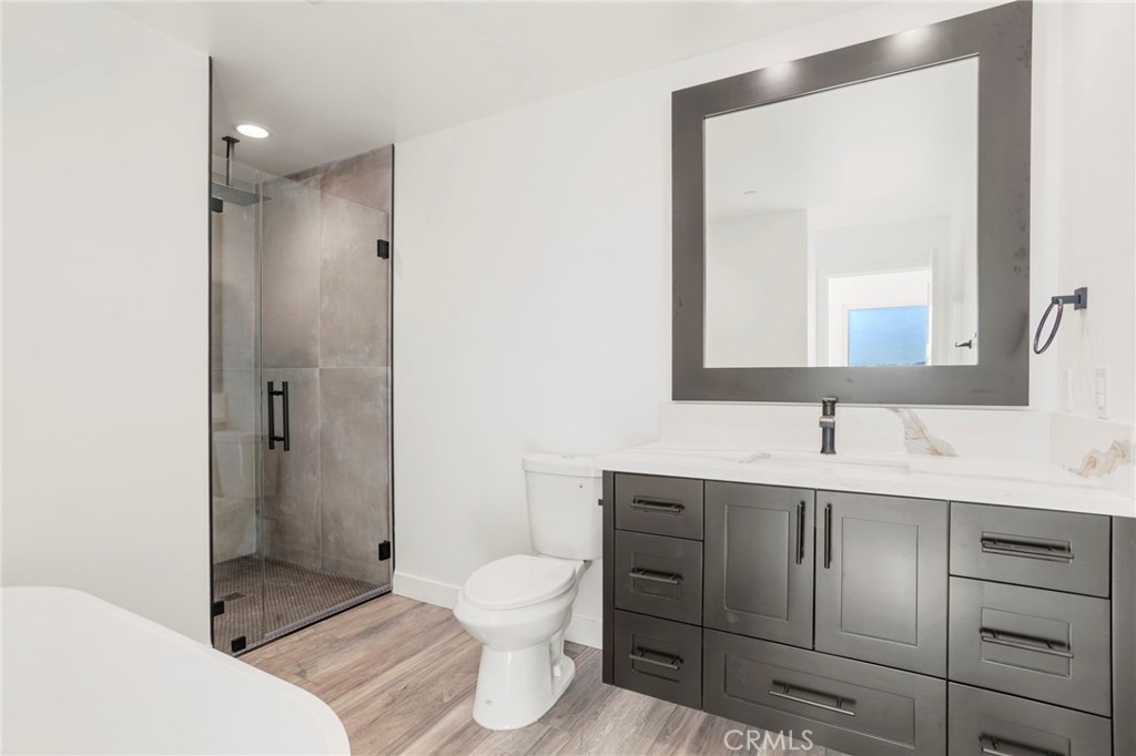 3460 Stonehill Avenue Joshua Tree, CA 92252 - Photo 20 of 27 a bathroom with a toilet sink vanity and mirror