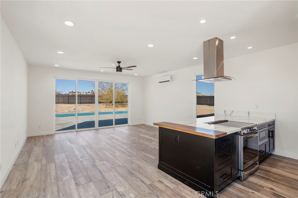 3460 Stonehill Avenue Joshua Tree, CA 92252 - Photo 5 of 27 a view of a kitchen with a sink and wooden floor