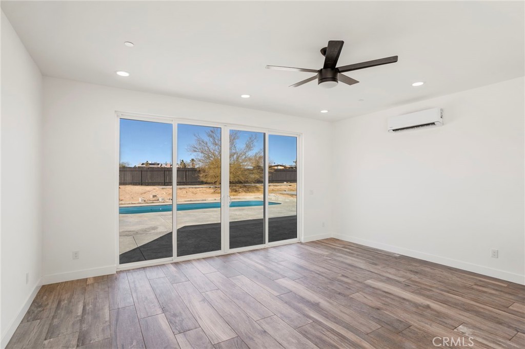 3460 Stonehill Avenue Joshua Tree, CA 92252 - Photo 8 of 27 wooden floor in an empty room with a window