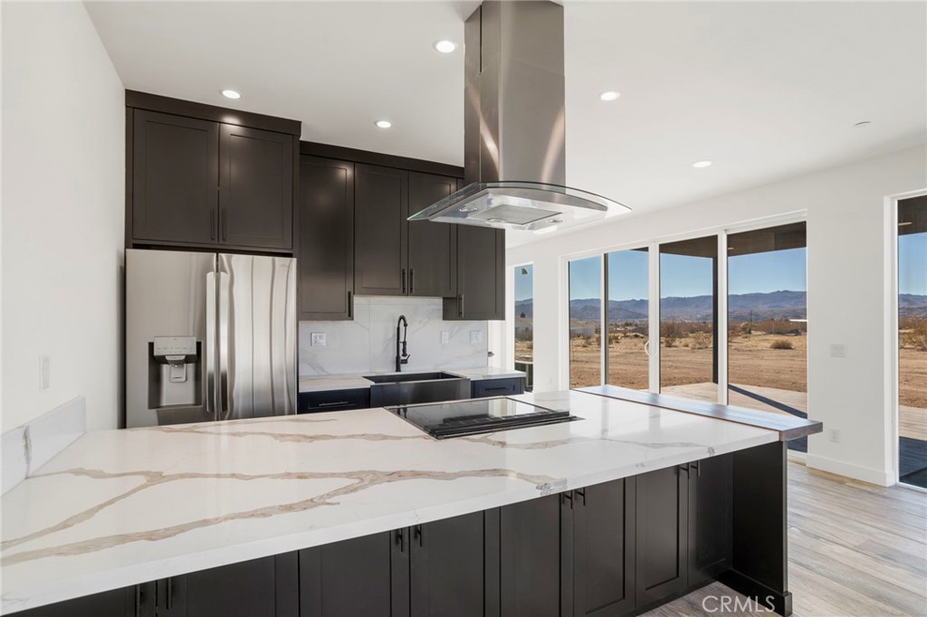 3460 Stonehill Avenue Joshua Tree, CA 92252 - Photo 9 of 27 a kitchen with a sink stainless steel appliances and cabinets