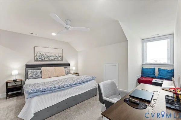 a bedroom with a bed and a television