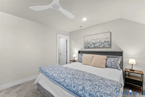 a kitchen with stainless steel appliances granite countertop a stove top oven a refrigerator a sink and a dining table with wooden floor