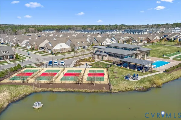 an aerial view of a house with a lake