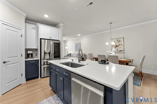 a kitchen with stainless steel appliances granite countertop a sink a stove and a refrigerator