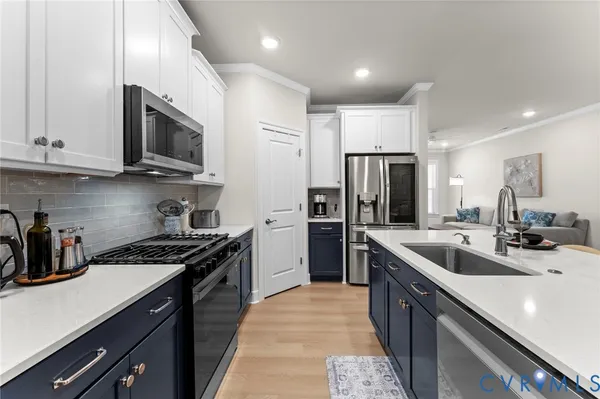 a kitchen with stainless steel appliances granite countertop a refrigerator and a stove top oven