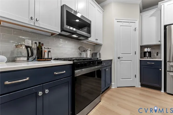 a kitchen with stainless steel appliances a refrigerator and cabinets