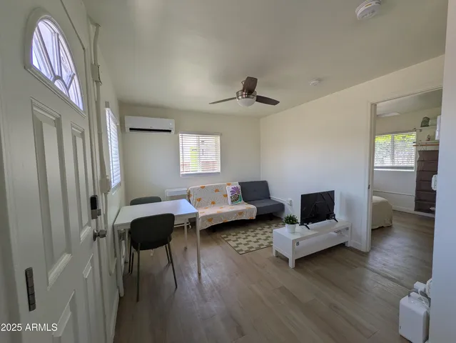 a living room with furniture and a wooden floor