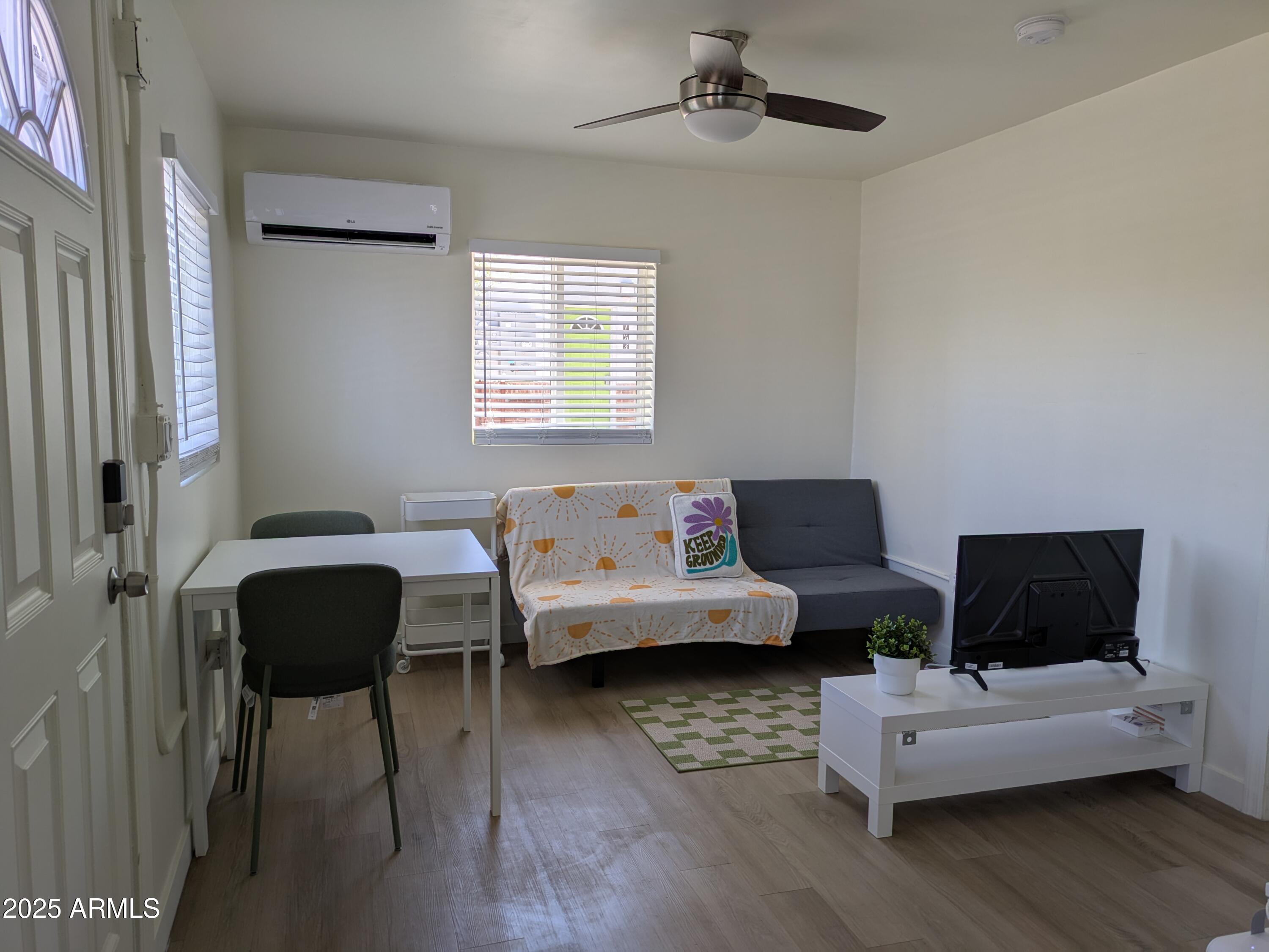 1620 East Apache Boulevard, Unit 1006 Tempe, AZ 85281 - Photo 2 of 12 a living room with furniture and a window