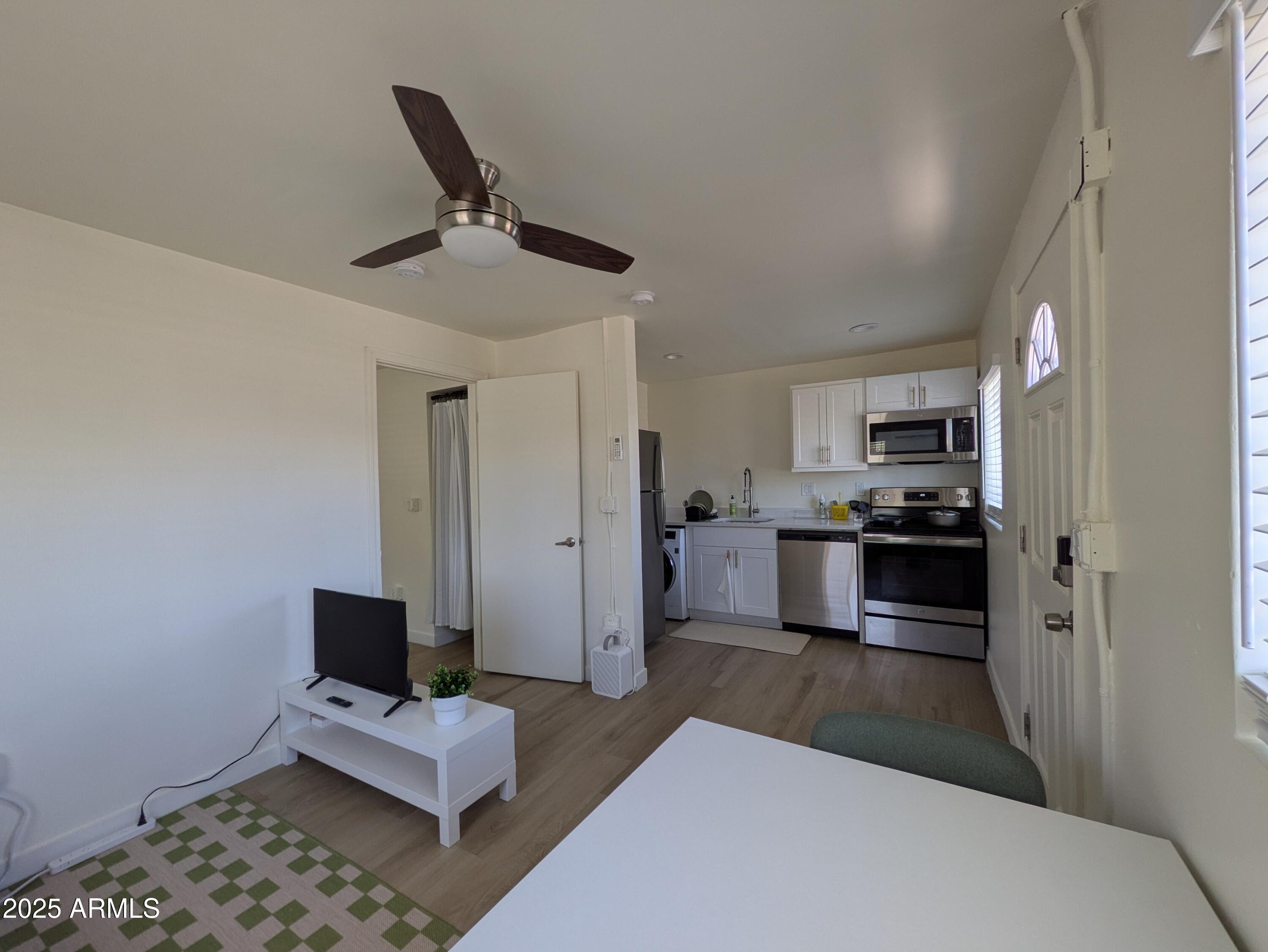 1620 East Apache Boulevard, Unit 1006 Tempe, AZ 85281 - Photo 3 of 12 a living room with furniture and a kitchen