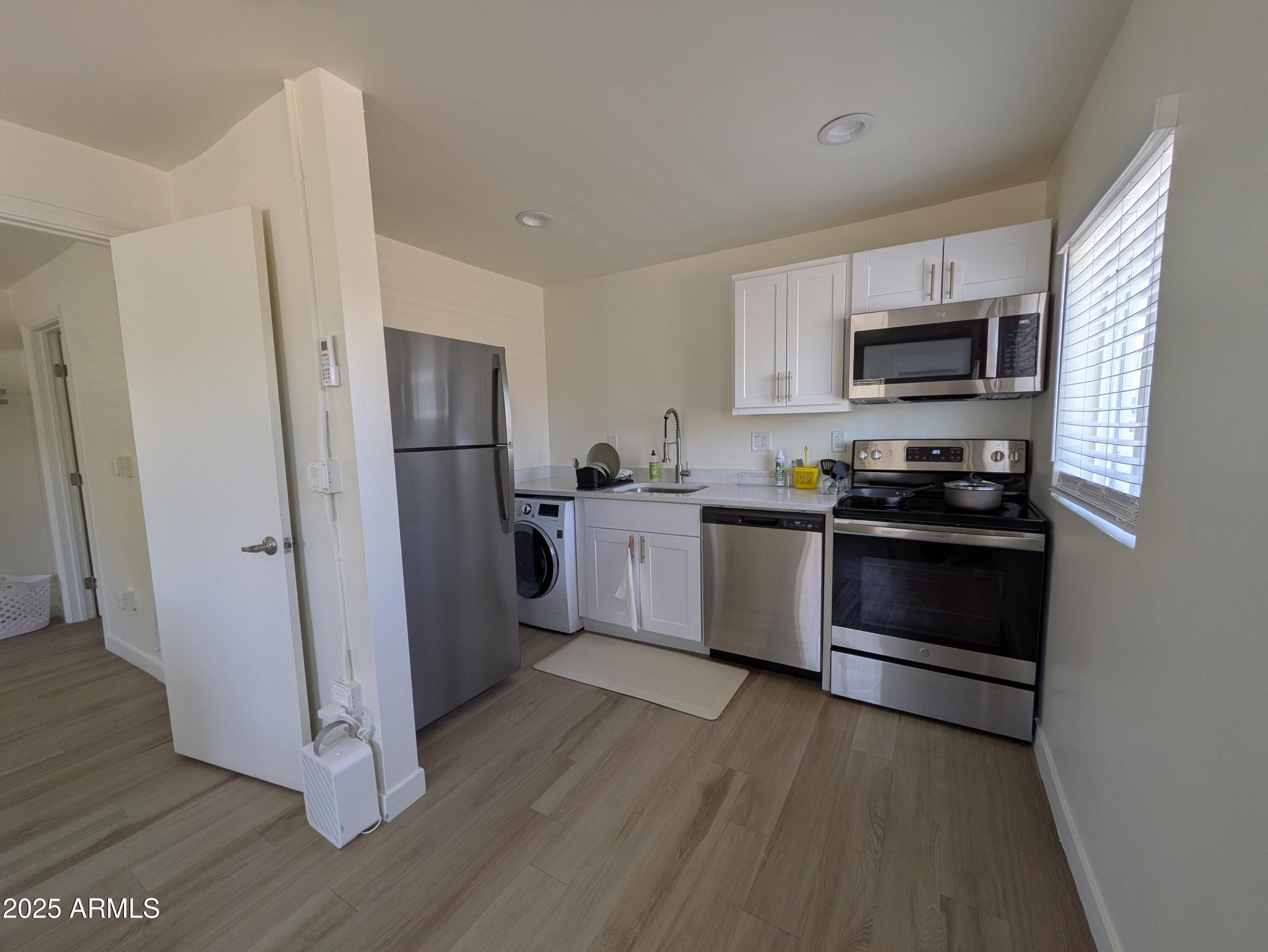 1620 East Apache Boulevard, Unit 1006 Tempe, AZ 85281 - Photo 5 of 12 a kitchen with a refrigerator and a stove top oven