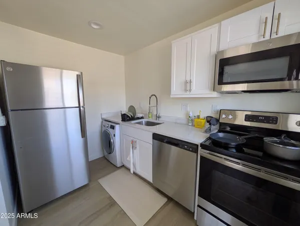 a kitchen with a refrigerator stove and microwave