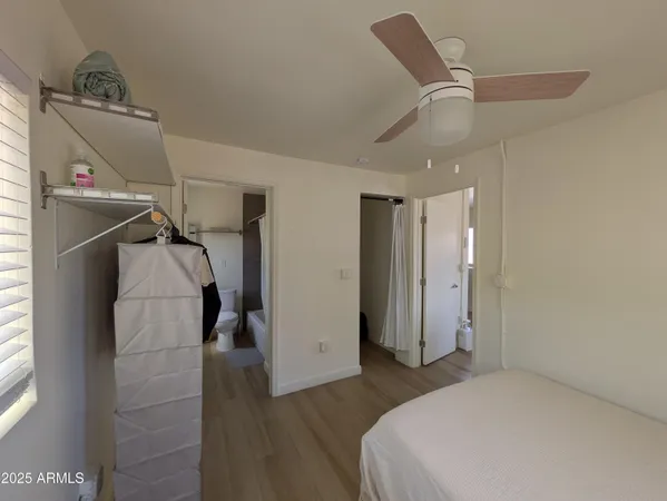 a bedroom with a bed and a ceiling fan