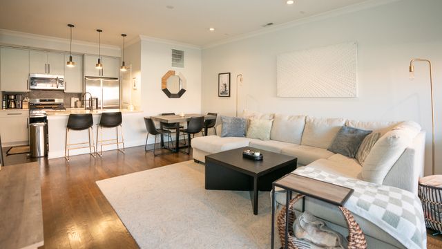 a living room with lots of furniture and a large window