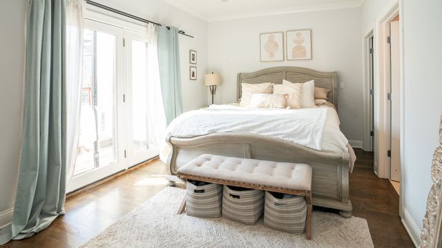 a bedroom with a bed and a window