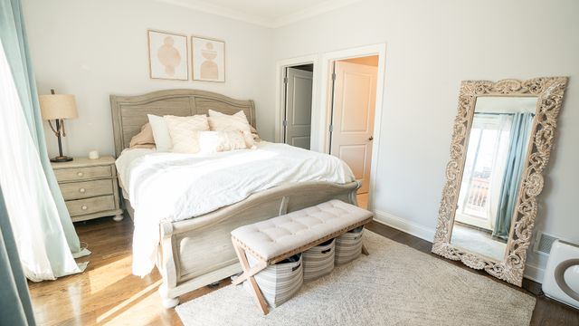 a bedroom with a bed and a mirror