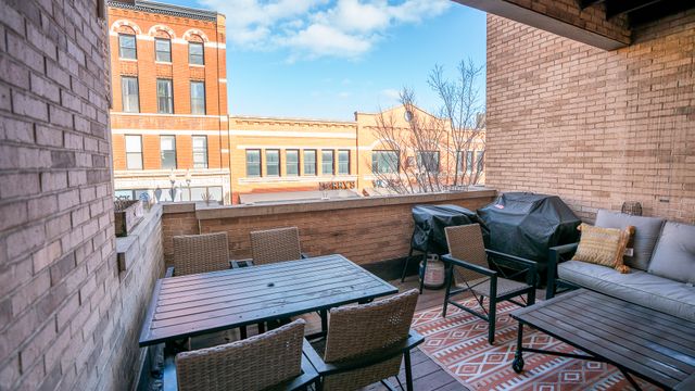 a roof deck with a table and chairs