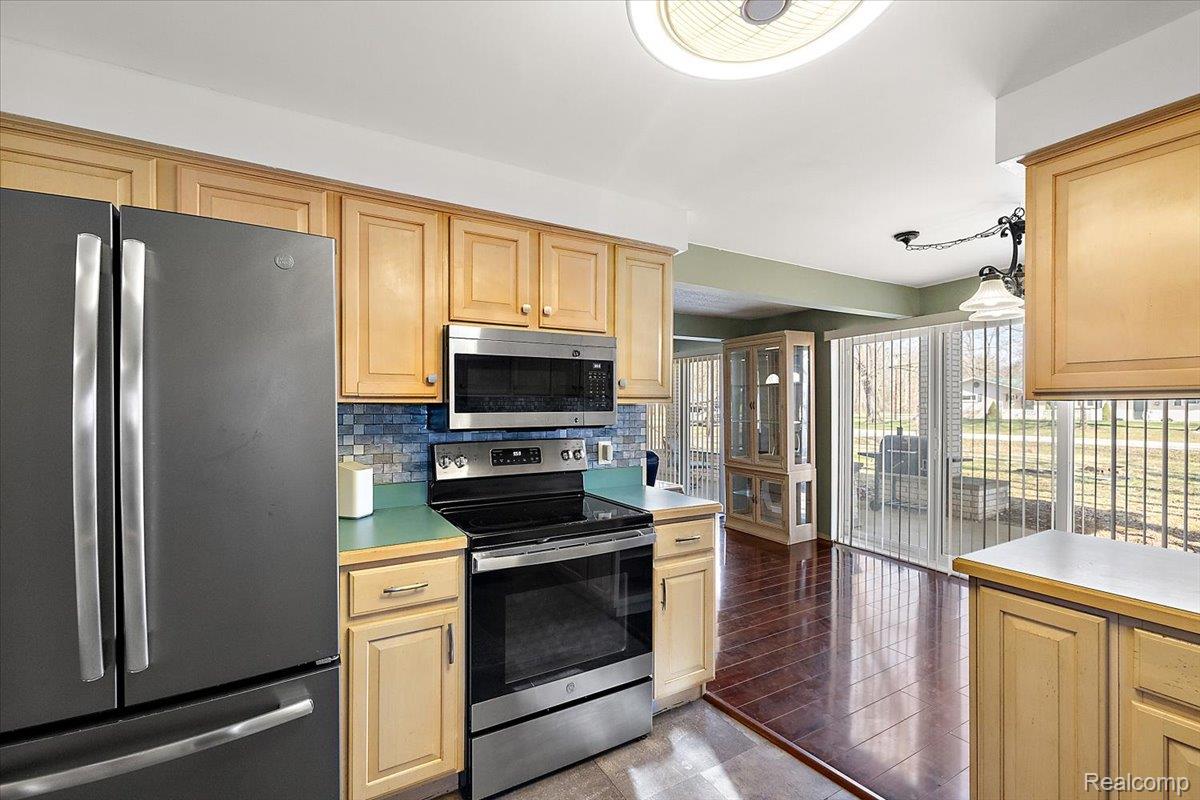 4705 Ketchum Road St. Clair, MI 48079 - Photo 24 of 58 Kitchen with stainless steel appliances, light countertops, tasteful backsplash, and dark tile patterned flooring