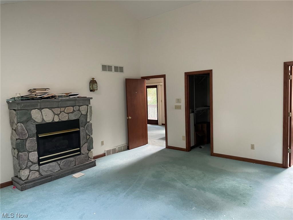 4088 Leffingwell Road Canfield, OH 44406 - Photo 25 of 35 Carpeted living room with a fireplace and a high ceiling