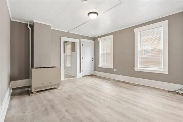 an empty room with windows and closet