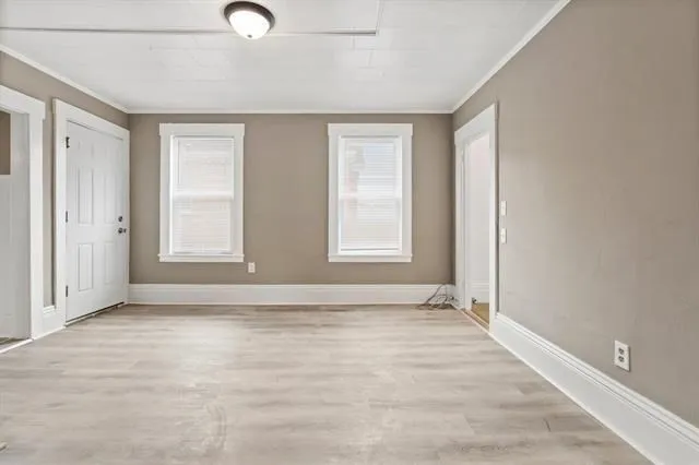 wooden floor in an empty room with a window