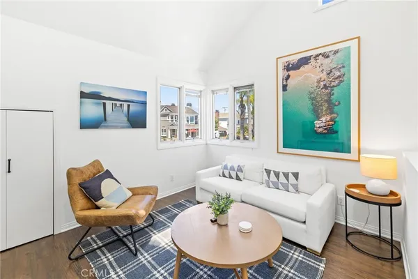 a living room with furniture and a painting on the wall