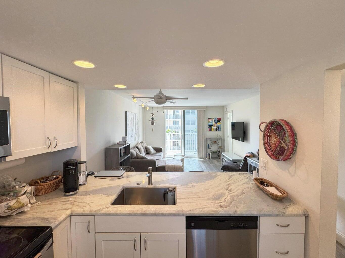 2929 South Ocean Boulevard, Unit 4130 Boca Raton, FL 33432 - Photo 1 of 17 a kitchen with a sink stove and cabinets