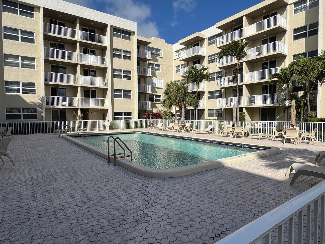 2929 South Ocean Boulevard, Unit 4130 Boca Raton, FL 33432 - Photo 15 of 17 a view of building with swimming pool and outdoor space