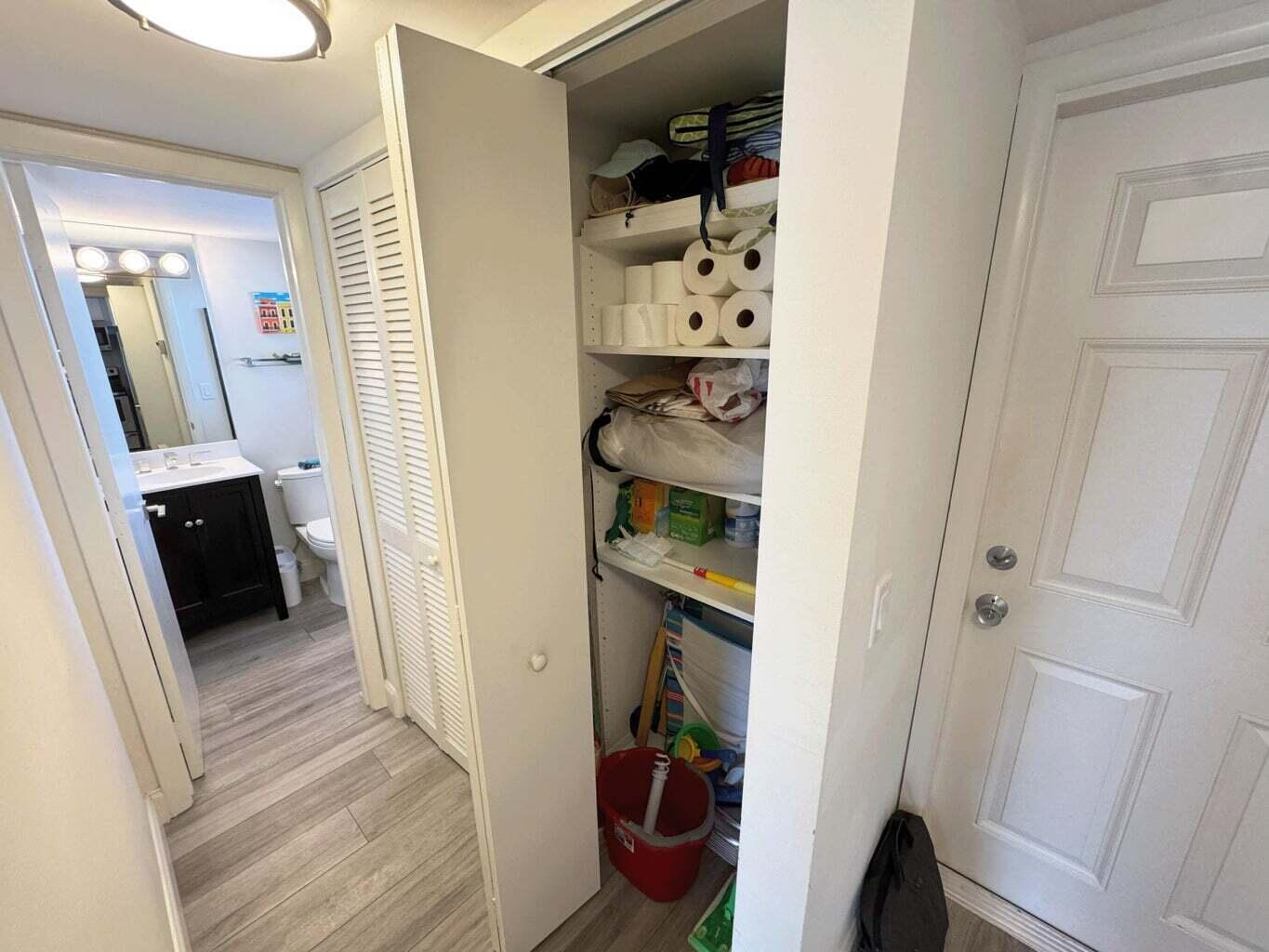 2929 South Ocean Boulevard, Unit 4130 Boca Raton, FL 33432 - Photo 9 of 17 walk in closet with wooden floor washer and dryer