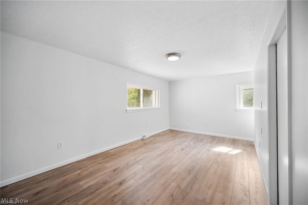 28300 Aurora Road Solon, OH 44139 - Photo 14 of 36 Light-filled interior space featuring wood-finish flooring, crisp white walls, and bright white trim