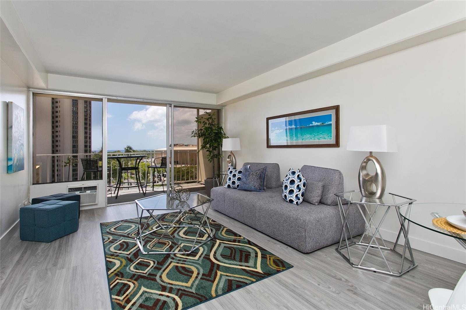 419 Atkinson Drive, Unit 906 Honolulu, HI 96814 - Photo 1 of 1 a living room with furniture and a large window