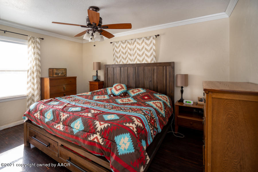 4207 South Lipscomb Street Amarillo, TX 79110 - Photo 12 of 23 a bedroom with a bed and a chandelier