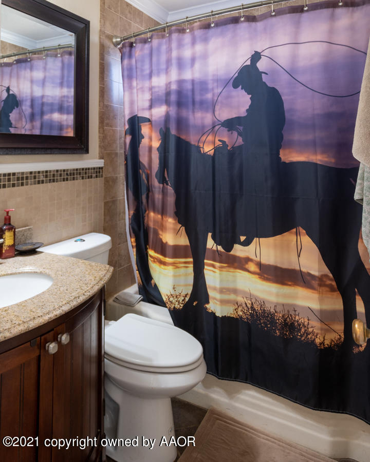 4207 South Lipscomb Street Amarillo, TX 79110 - Photo 15 of 23 a bathroom with a granite countertop sink and a toilet