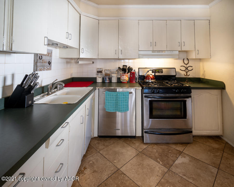 4207 South Lipscomb Street Amarillo, TX 79110 - Photo 8 of 23 a kitchen with a stove and a sink