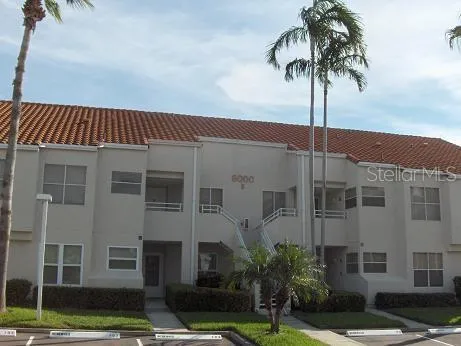 front view of a building with a palm tree