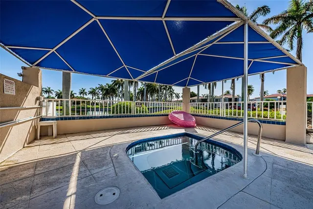 a view of a roof deck with a table and chairs under an umbrella