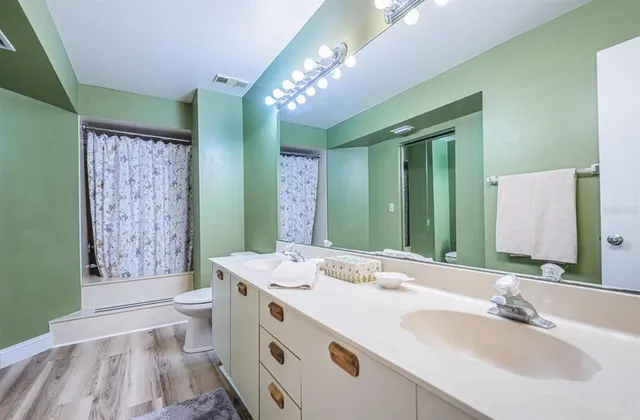 a spacious bathroom with a double vanity sink mirror and shower
