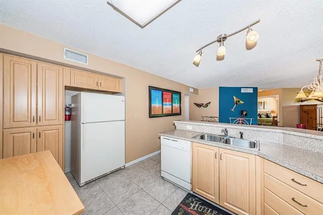 a kitchen with a sink and refrigerator