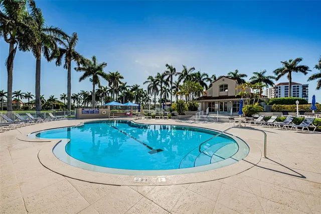 a view of a swimming pool with outdoor seating