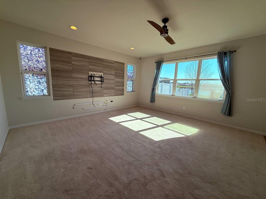 14112 Poke Ridge Drive Riverview, FL 33579 - Photo 3 of 32 an empty room with windows and ceiling fan