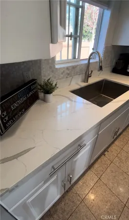 a kitchen with a sink and a stove