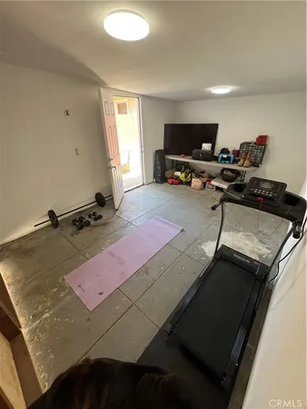 a room with gym equipment and a large window