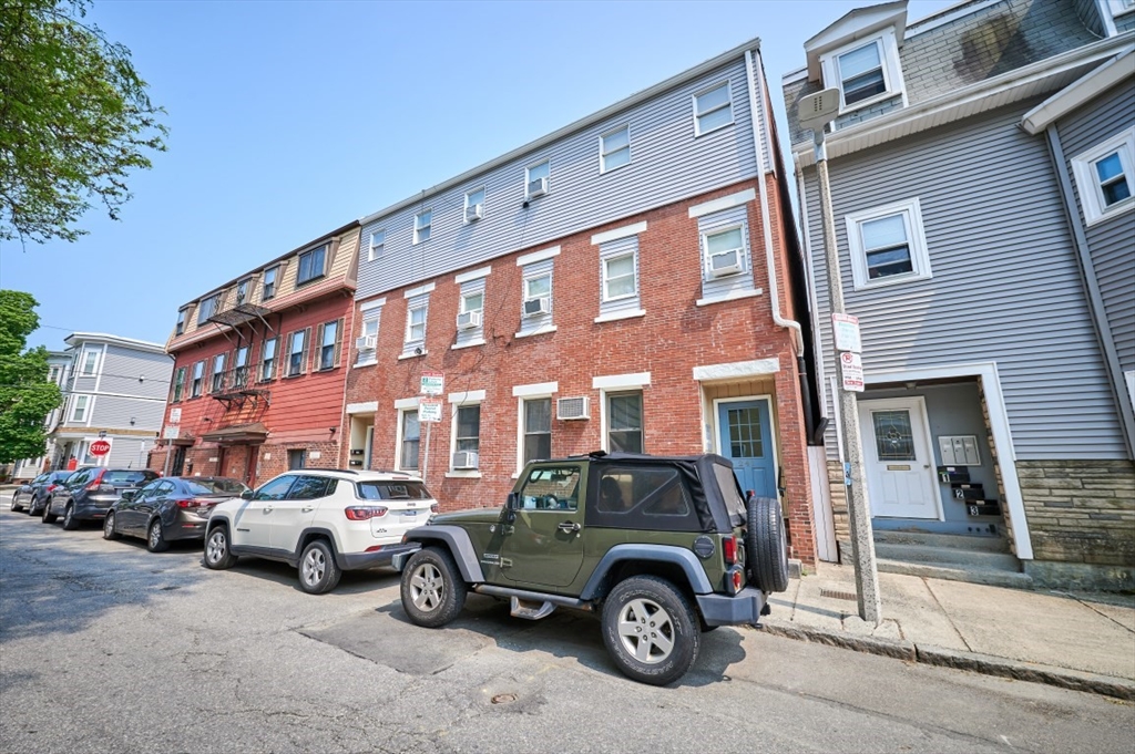 241-243 E Street Boston, MA 02127 - Photo 1 of 16 a car parked in front of a building