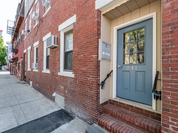 a view of a brick buildings with entryway doors