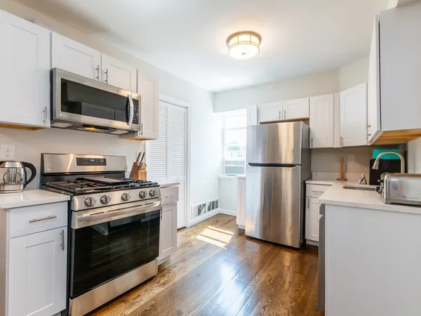 a kitchen with a stove a microwave and refrigerator