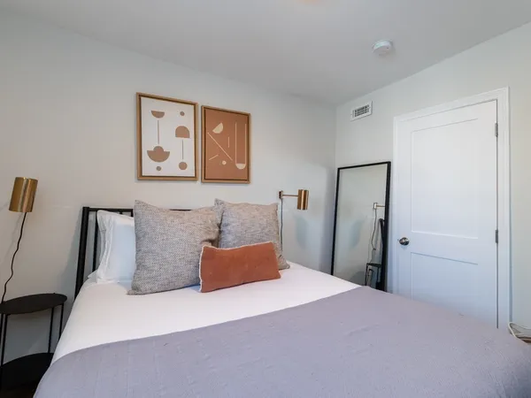 a bedroom with bed and cupboard