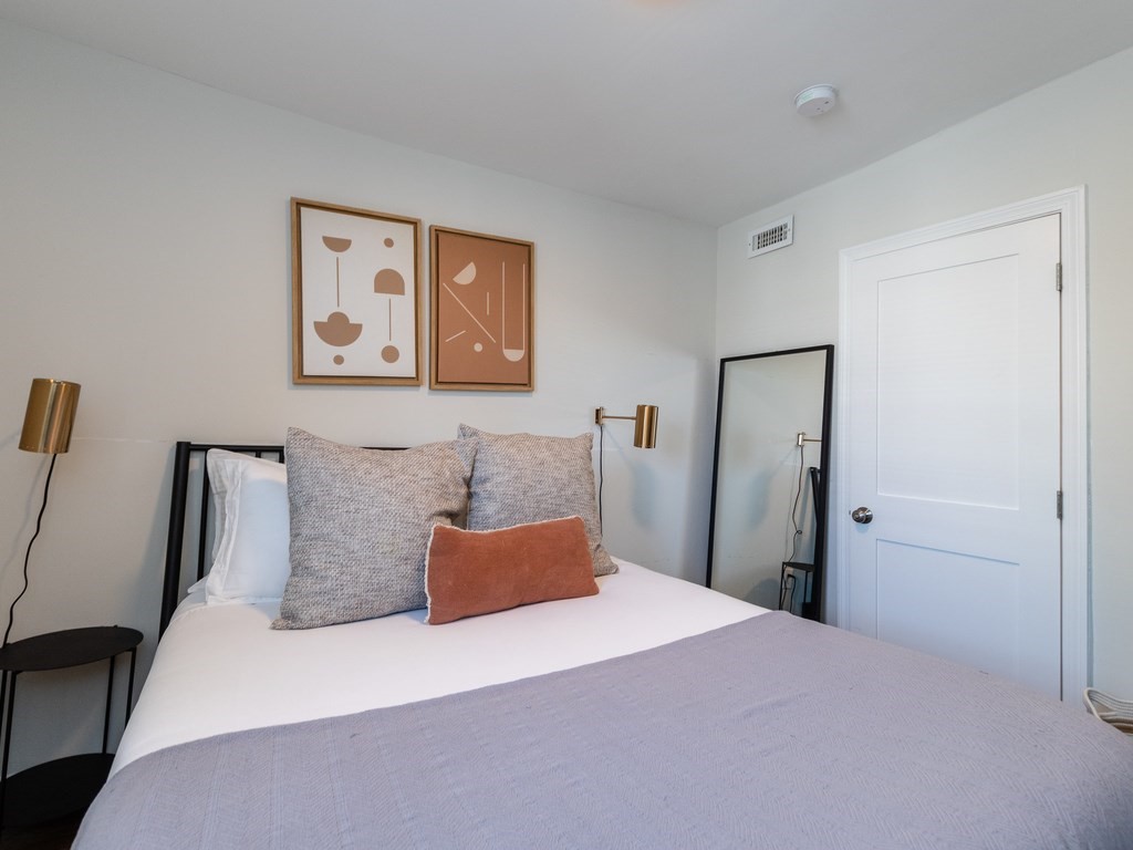 241-243 E Street Boston, MA 02127 - Photo 15 of 16 a bedroom with bed and cupboard